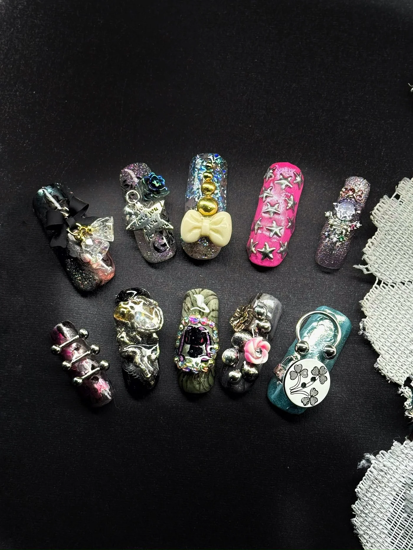 Press-on nail designs on a dark background