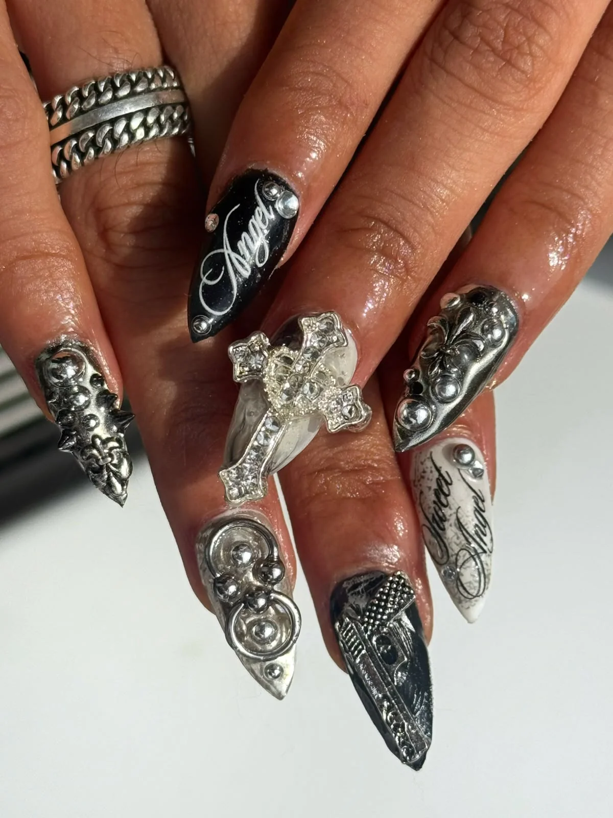 Metallic black and silver sculptural nails